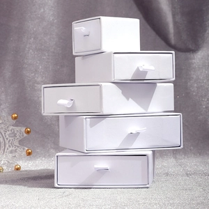 Minimalist white drawer-style jewelry gift boxes with ribbon handles for premium packaging