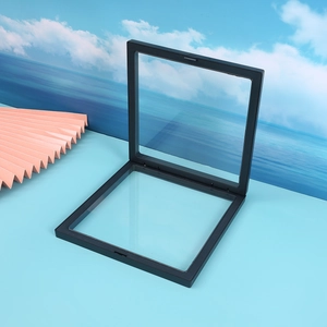 Black square PE film floating jewelry display box for rings shown on a blue background