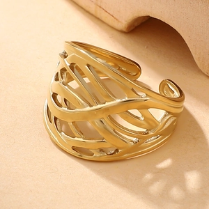 Detailed view of gold woven hollow wide band ring with adjustable feather leaf texture