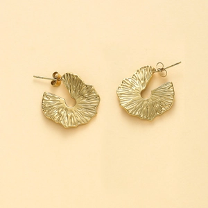 Detailed close-up of bohemian 14K gold plated irregular ruffle fan earrings with radial texture