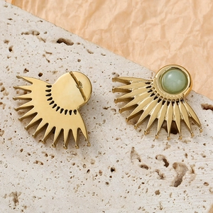 Detailed close-up of fan-shaped gold earrings with green natural stone and sunburst pattern