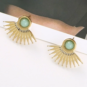 Macro view of gold fan-shaped stud earrings with light green natural stone inlay