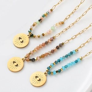 Bohemian stainless steel beaded necklace set with evil eye charms on a minimal background
