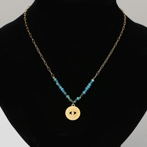 Detail view of Bohemian evil eye pendant with blue beads on a black jewelry stand