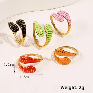 Macro detail of five colorful enamel snake rings with gold stripes and adjustable bands