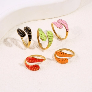 Detail of five colorful adjustable snake rings with ribbed texture and gold finish