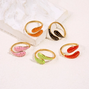 Close-up of adjustable snake-style rings with colorful enamel stripes on gypsum stone base