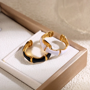 Bamboo style open rings in gold finish with black and white enamel in a jewelry box