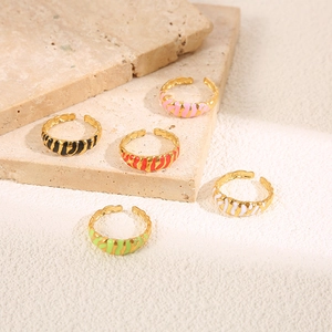 Detailed view of colorful enamel tiger stripe open rings in gold-plated stainless steel