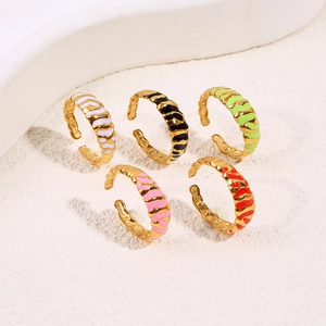 Set of five adjustable enamel wave rings in gold-plated steel featuring vibrant colors