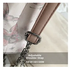 Detail of adjustable pink leather strap with silver metal buckle on butterfly tote bag