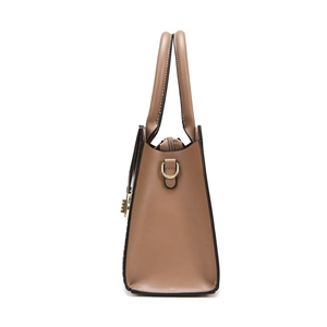 Brown faux leather handbag with stone texture and gold hardware on white background
