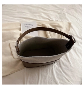 Top view of two-tone bucket bag showing leather bottom and woven fabric interior space