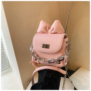 Detail of pink mini bow handbag featuring silver chain, pearls and textured PU leather