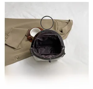 Interior view of beige shell bag showing inner lining and functional zipper pocket