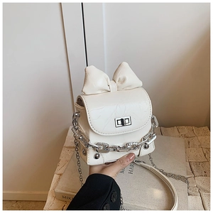 Detail of cream mini bow bag with micro-pleated leather, silver lock and chain strap