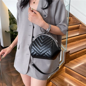 Retro black quilted shell bag with silver round handle and metal chain shoulder strap