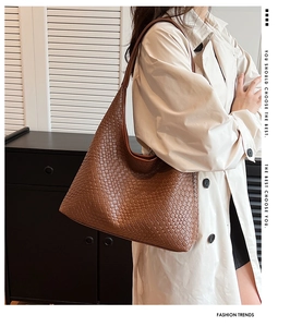 Close-up of brown woven leather hobo bag showing texture and large capacity design