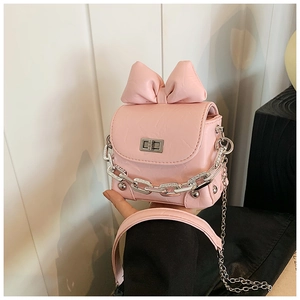 Close-up of pink mini box bag featuring a large bow detail and silver chain decoration