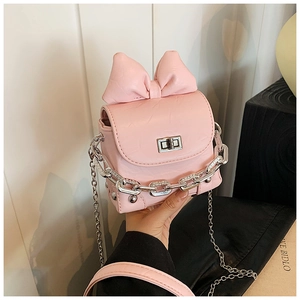 Detailed view of pink mini box bag with large bow decoration and silver chain strap