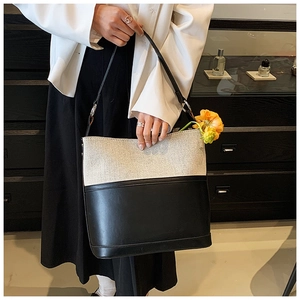 Detailed shot of retro bucket bag in canvas and leather with yellow flower charm