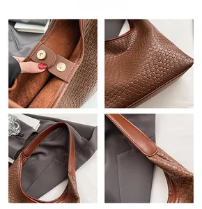 Close-up of woven leather tote with magnetic buckle closure and suede lining details
