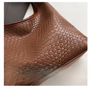 Close-up view of dark brown woven texture on a premium large capacity tote bag