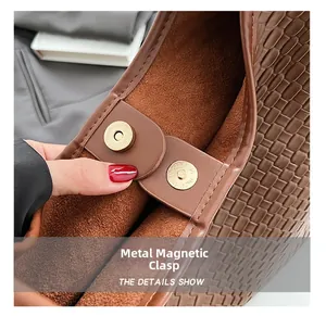 Detail view of woven brown tote bag featuring premium hardware magnetic snap closure