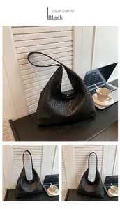 Close-up of black woven hobo bag showing large capacity and textured vegan leather