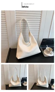 Close-up of white woven Intrecciato hobo bag showing detailed texture and soft vegan leather