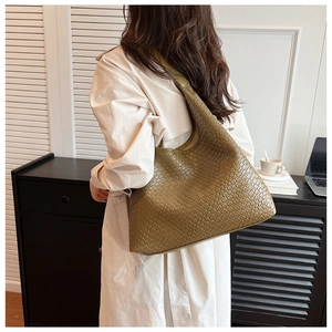 Detailed close-up of premium woven texture on olive green hobo tote shoulder bag