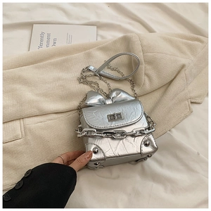 Detailed view of silver metallic bow-knot box bag with chain strap and twist-lock