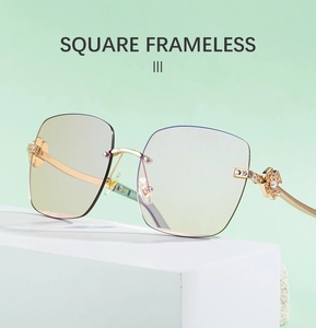 Detail of square frameless sunglasses with gold metal clover rhinestone accents