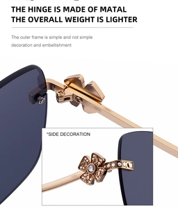 Detail of rimless sunglasses hinge with golden metal temple and rhinestone flower decor