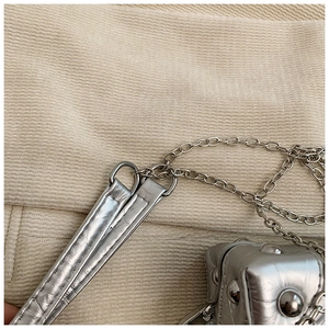 Detail of silver metallic handbag with metal chain strap and rivet embellishments