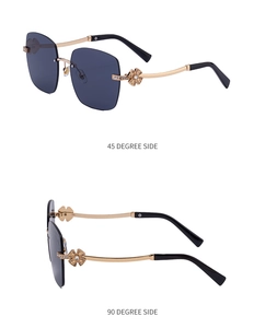 Close-up of frameless sunglasses with gradient lenses and rhinestone flower details