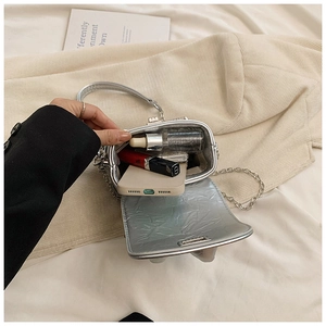 Silver metallic chain bag interior capacity showing phone, lipstick and skincare items