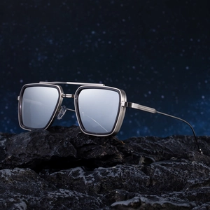 Retro square metal sunglasses with double bridge and silver mirror lenses on volcanic rock