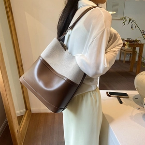 Minimalist canvas and brown leather patchwork tote bag for casual daily commuting
