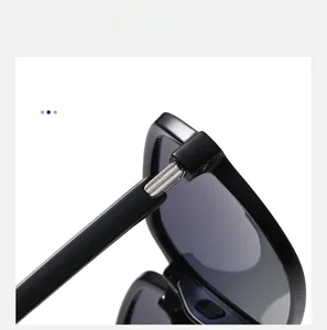 Detail of high-quality silver metal reinforced hinges on glossy black square sunglasses