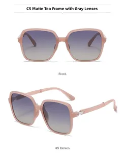 Detail view of large square folding sunglasses with tea frame and gradient lenses