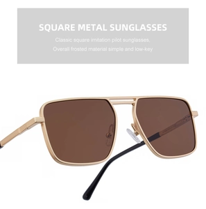 Detail of square gold metal sunglasses with matte finish and brown polarized lenses