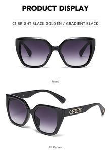 Detail of black cat-eye sunglasses featuring golden floral pattern on side temples