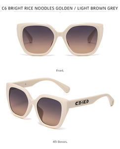 Cat eye sunglasses with beige frame and floral metal pattern on temples
