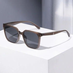 Modern square polarized sunglasses with brown frame and metal accents on white stand