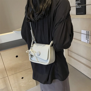 Chic light gray lychee pattern saddle bag with pearl bow charm and flap closure