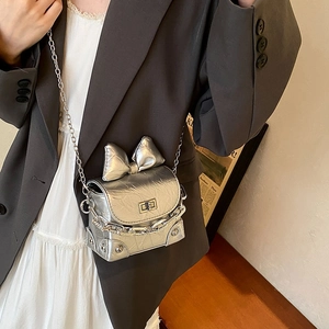 Mini silver bow crossbody bag with metallic leather and chain strap for women