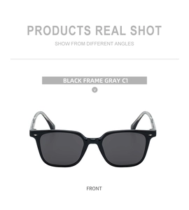 Close-up of square frame sunglasses with black glossy finish and silver rivet details