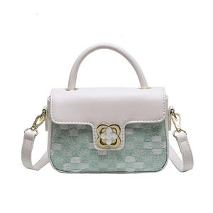 White leather and green woven crossbody bag with gold floral clasp on white backdrop