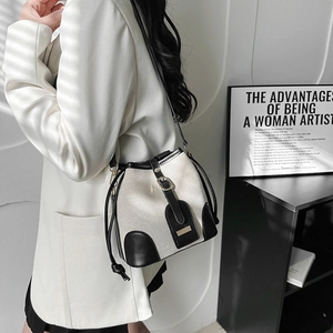 Retro canvas and leather bucket bag in black and white contrast with gold hardware